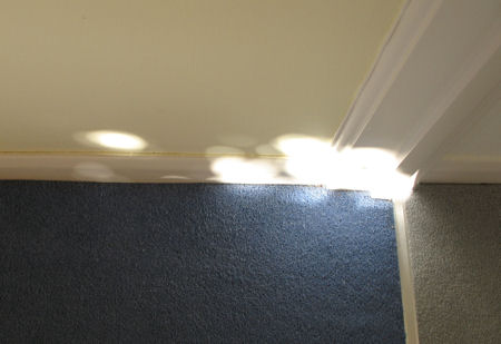 Spots of light on a skirting board
